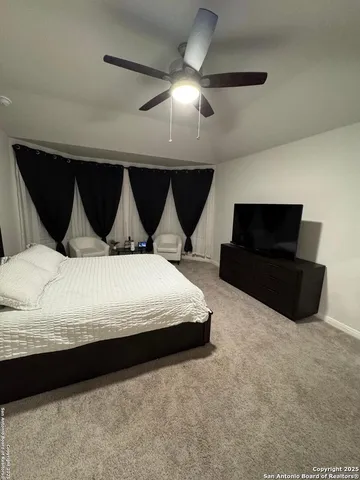 a bedroom with bed and window