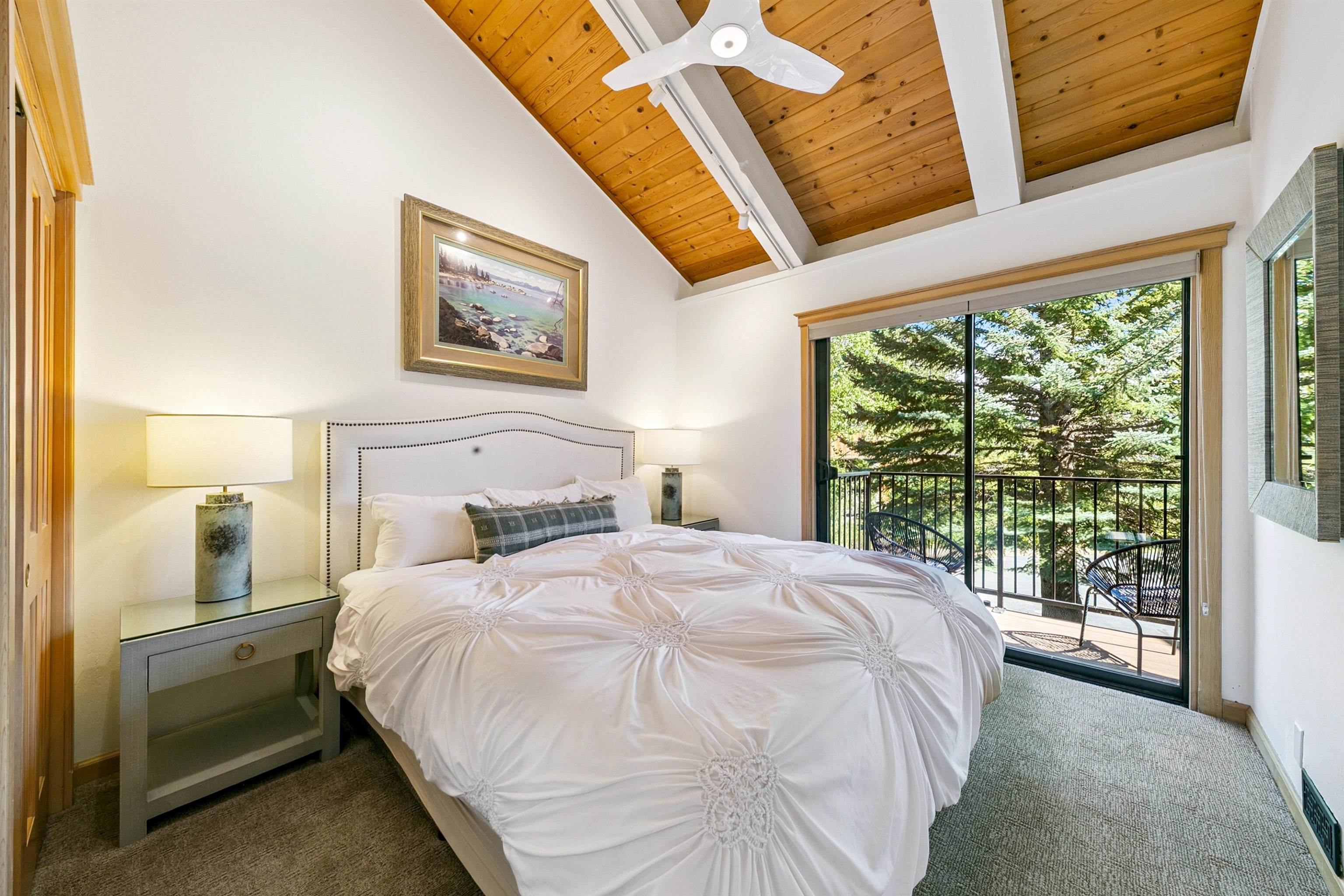 2560 Lake Forest Road, Unit 24 Tahoe City, CA 96145 - Photo 13 of 28 a bedroom with a bed and a large window