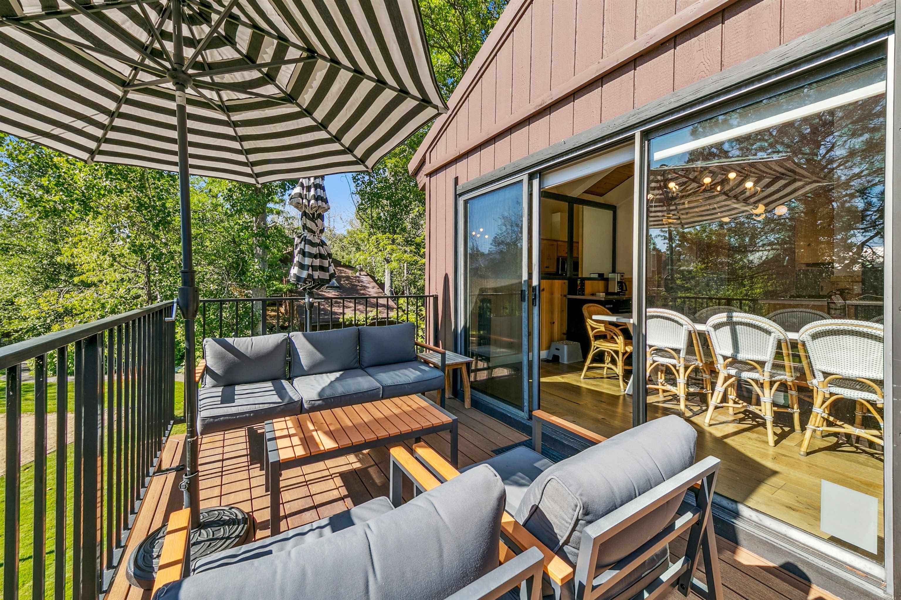 2560 Lake Forest Road, Unit 24 Tahoe City, CA 96145 - Photo 20 of 28 a view of a patio with couches chairs dining table and chairs barbeque grill with wooden fence