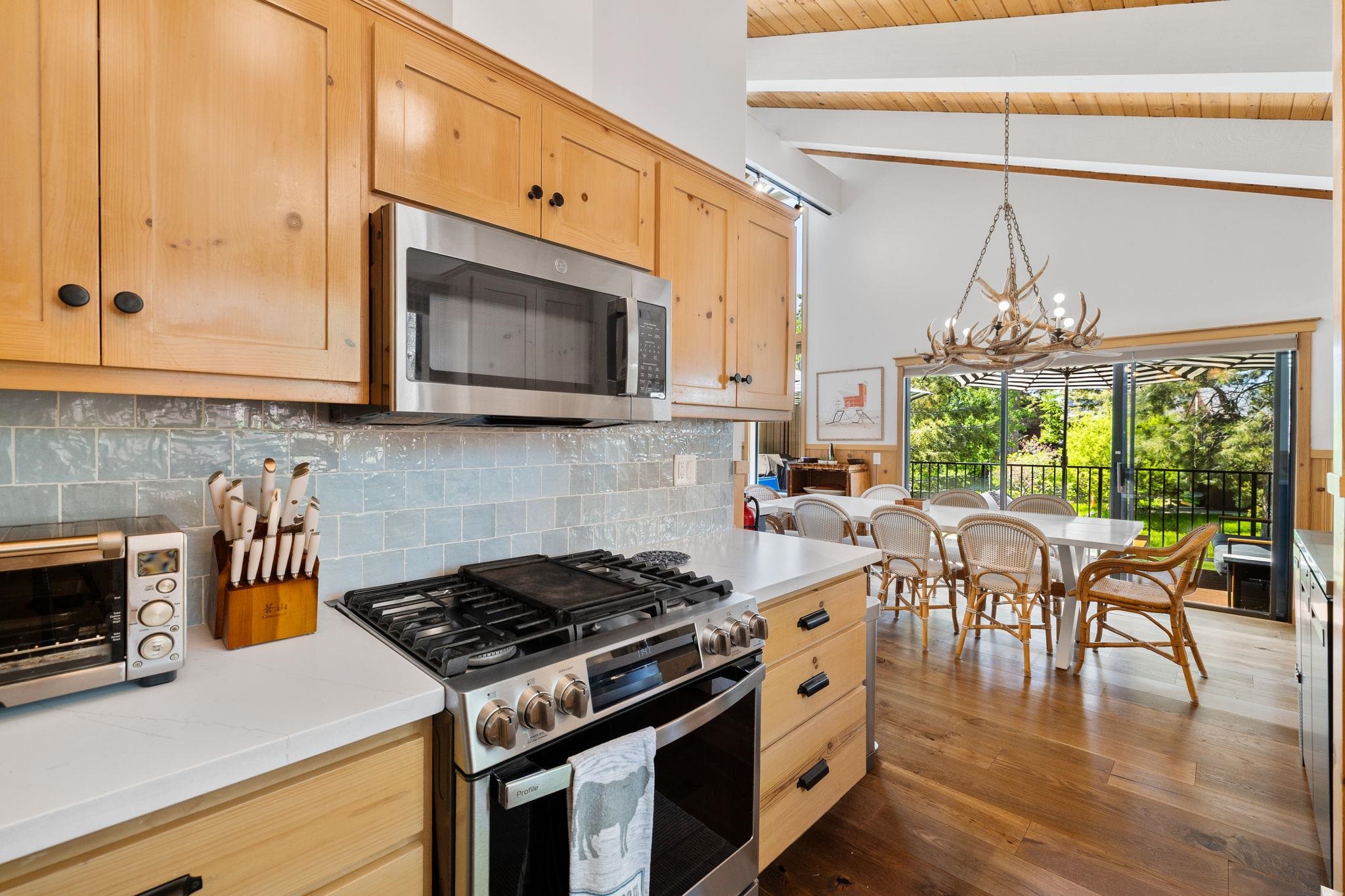 2560 Lake Forest Road, Unit 24 Tahoe City, CA 96145 - Photo 6 of 28 a kitchen with stainless steel appliances granite countertop a stove a sink and a microwave