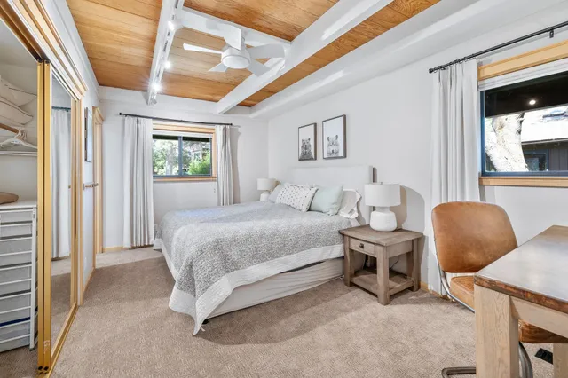 a bathroom with a sink vanity mirror and toilet