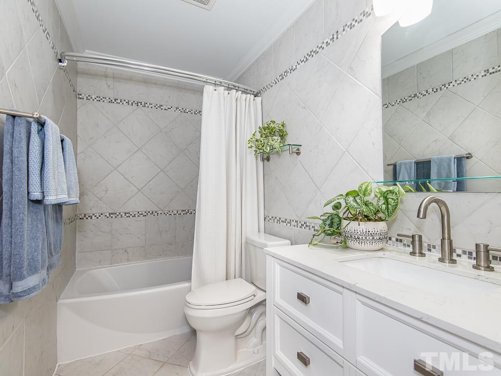 1312 South State Street, Unit D Raleigh, NC 27610 - Photo 14 of 19 a bathroom with a granite countertop sink a toilet and shower