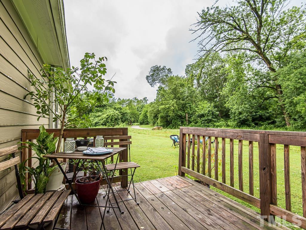 1312 South State Street, Unit D Raleigh, NC 27610 - Photo 15 of 19 a view of balcony with chairs and wooden floor