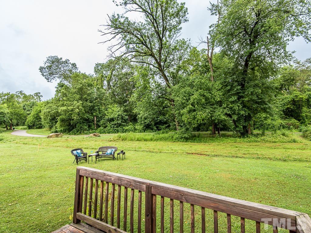 1312 South State Street, Unit D Raleigh, NC 27610 - Photo 19 of 19 a view of a deck with an outdoor space and trees