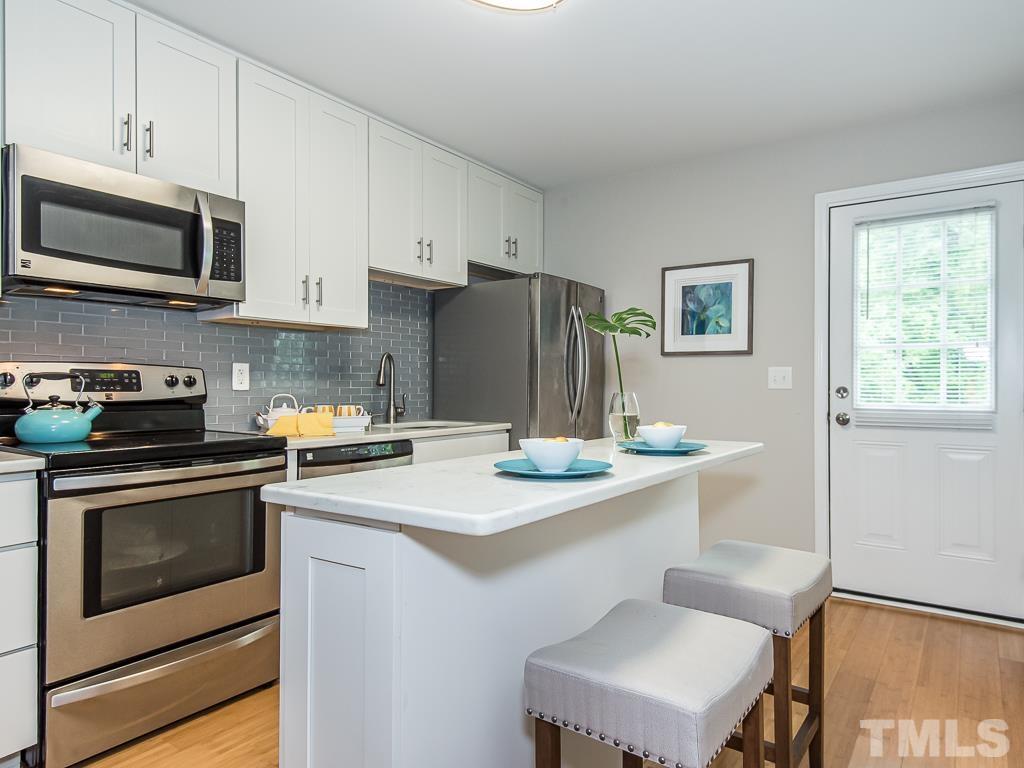 1312 South State Street, Unit D Raleigh, NC 27610 - Photo 8 of 19 a kitchen with stainless steel appliances a stove microwave and sink