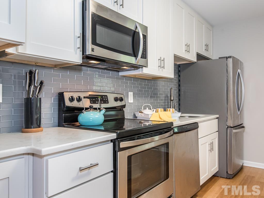 1312 South State Street, Unit D Raleigh, NC 27610 - Photo 10 of 19 a kitchen with stainless steel appliances a stove microwave and refrigerator