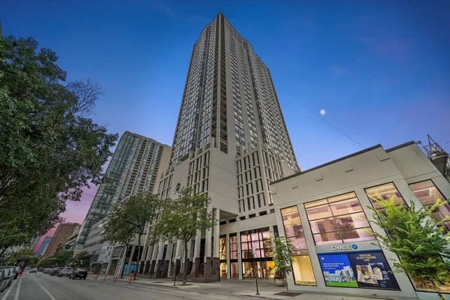 a view of a tall building next to a road