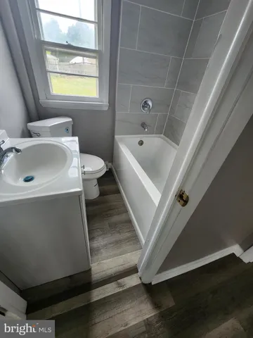 a bathroom with a sink a toilet and bathtub
