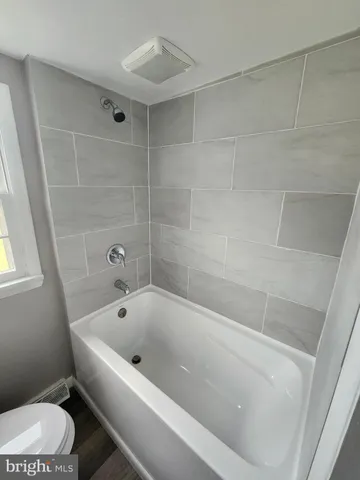 a view of a grassy field with trees in the background