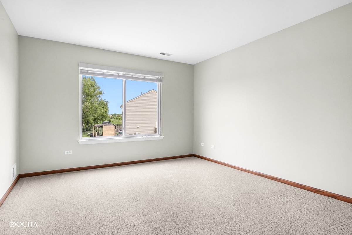 2413 Roxbury Lane Montgomery, IL 60538 - Photo 13 of 22 an empty room with a window