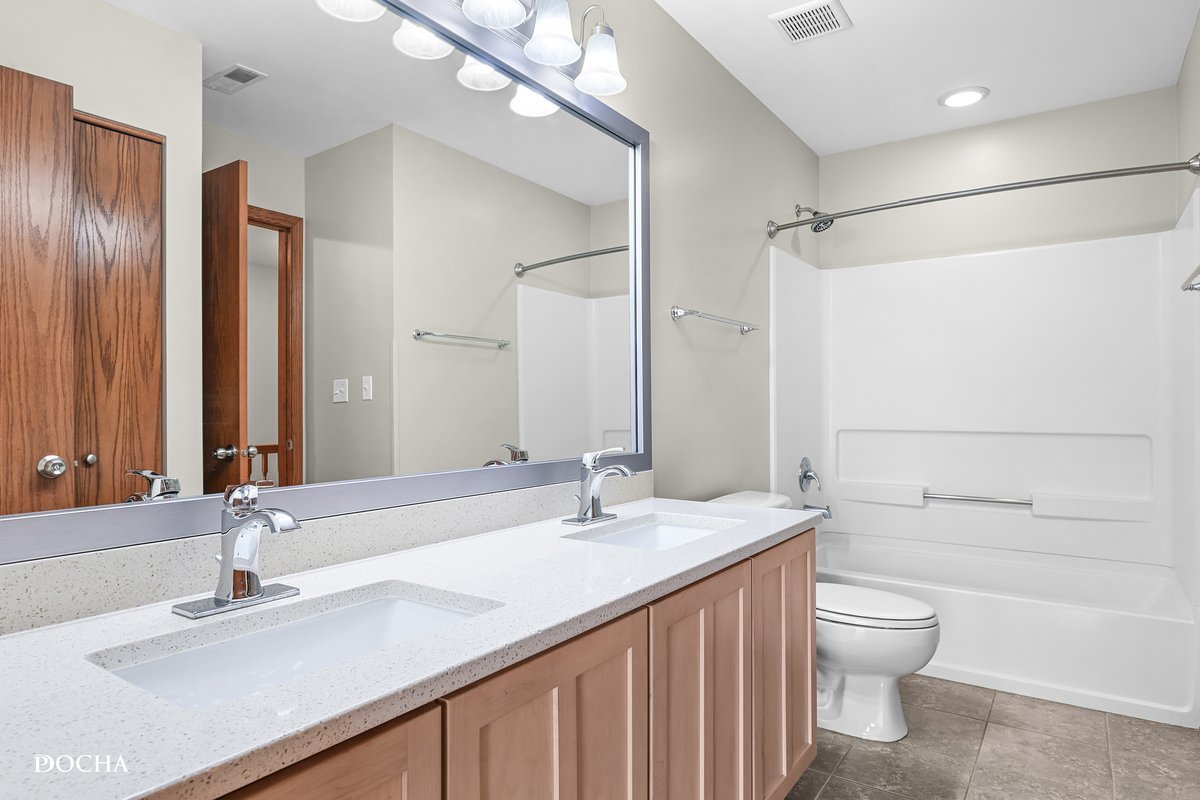 2413 Roxbury Lane Montgomery, IL 60538 - Photo 17 of 22 a bathroom with a granite countertop sink toilet a large mirror and shower