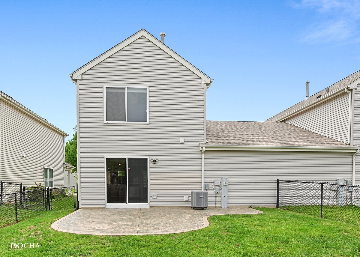 2413 Roxbury Lane Montgomery, IL 60538 - Photo 20 of 22 a view of a house with a yard and a garage