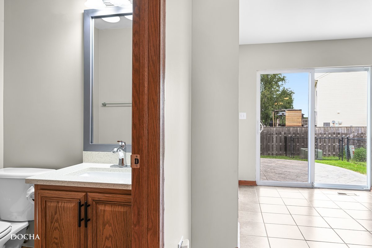 2413 Roxbury Lane Montgomery, IL 60538 - Photo 9 of 22 a bathroom with a sink and a mirror