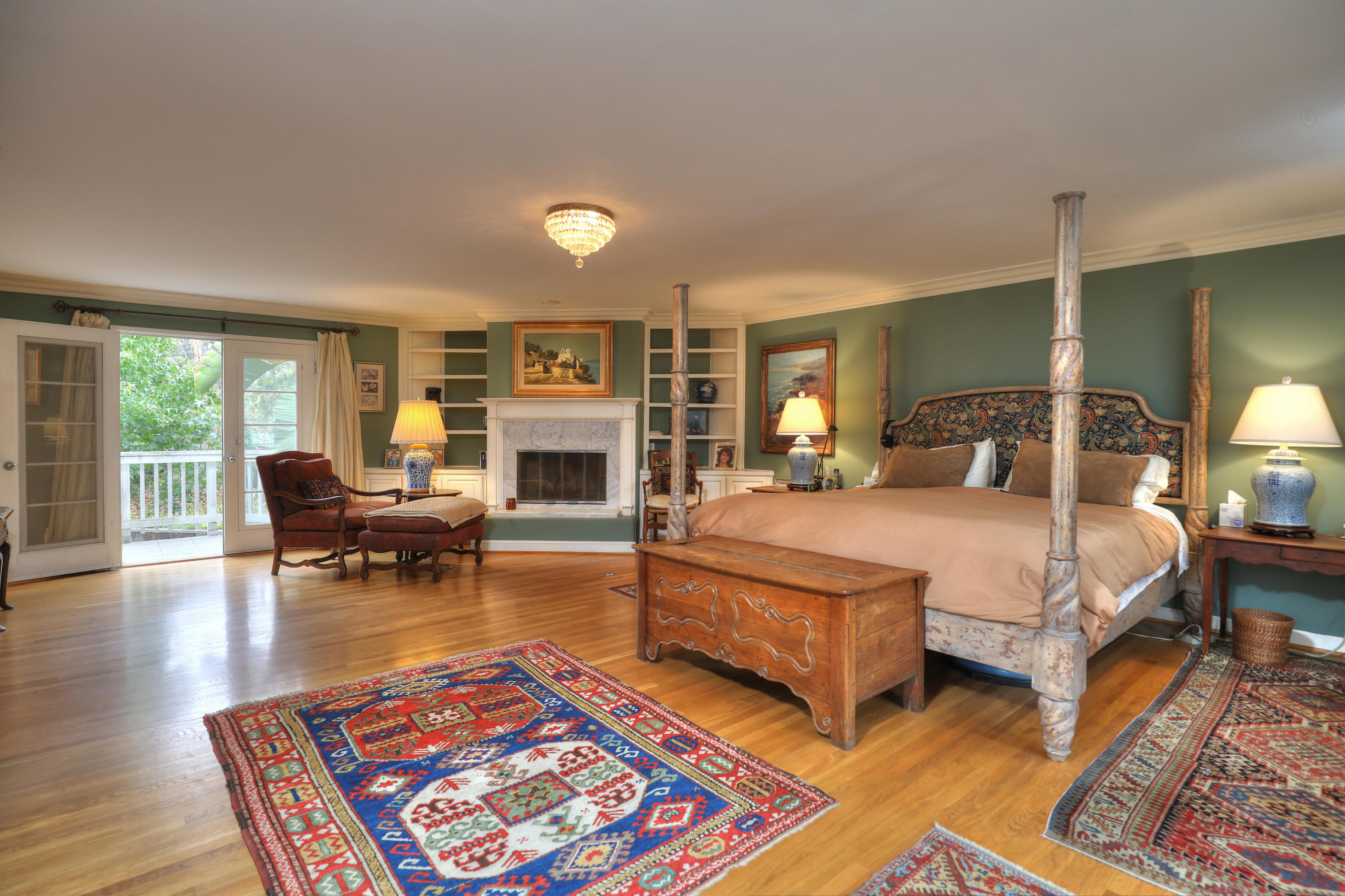 189 Hermosillo Road Montecito, CA 93108 - Photo 17 of 23 a spacious bedroom with a bed a table and a fireplace