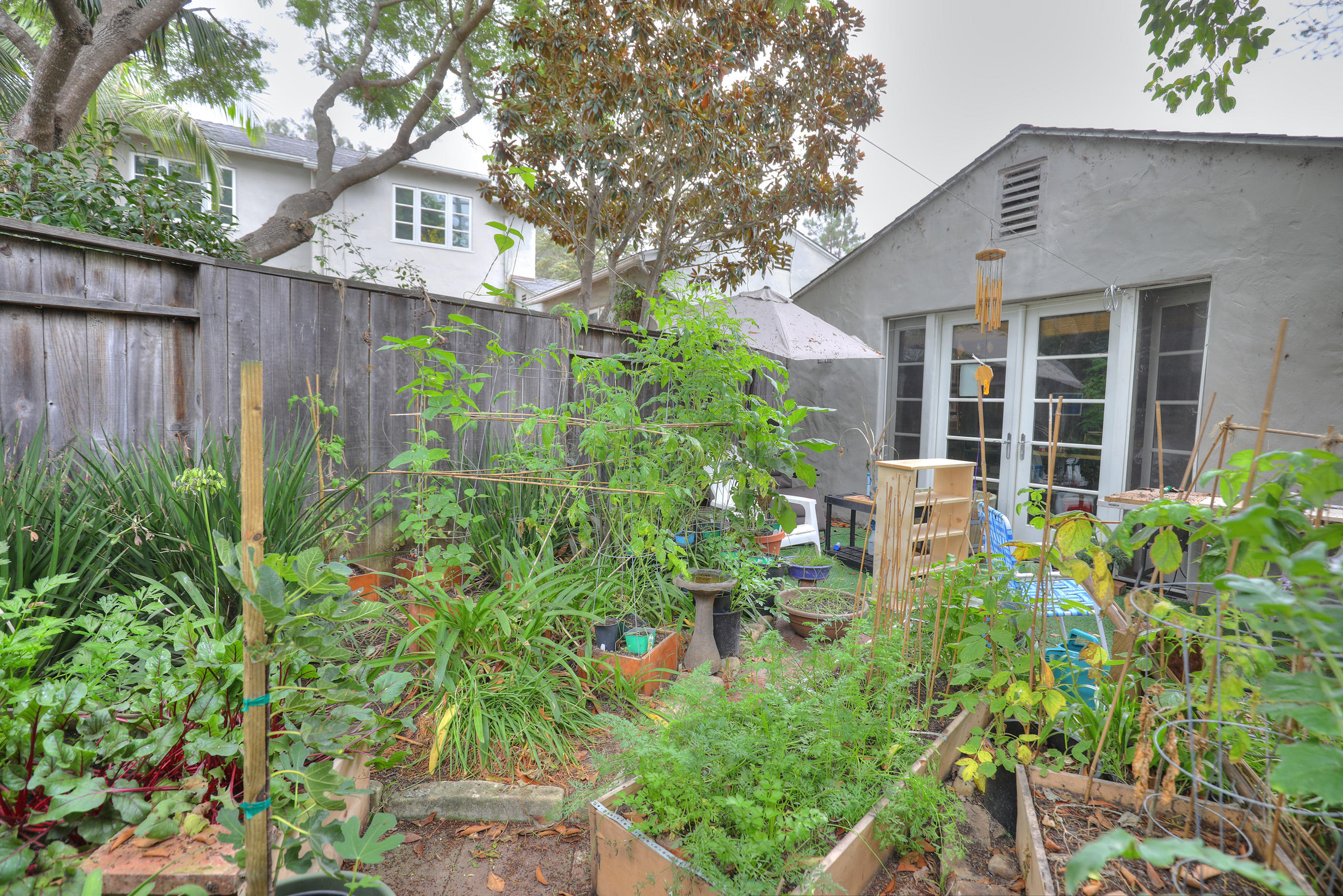 189 Hermosillo Road Montecito, CA 93108 - Photo 22 of 23 a view of a house with brick walls and a flower garden