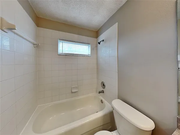 a white bath tub sitting next to a white toilet