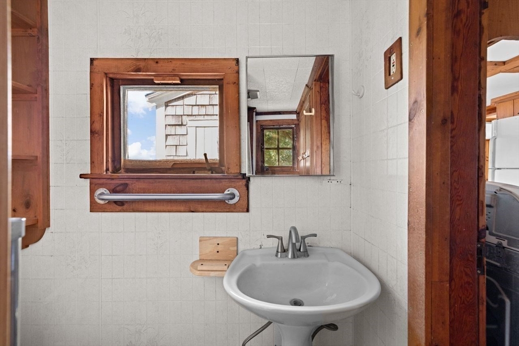 26 Damons Point Circle Marshfield, MA 02050 - Photo 13 of 35 a bathroom with a sink a mirror and a toilet