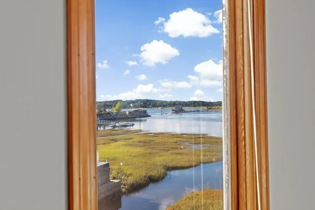a living room with hard wood floors and a table