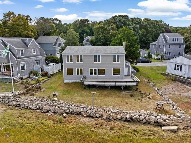 an aerial view of a house with a yard