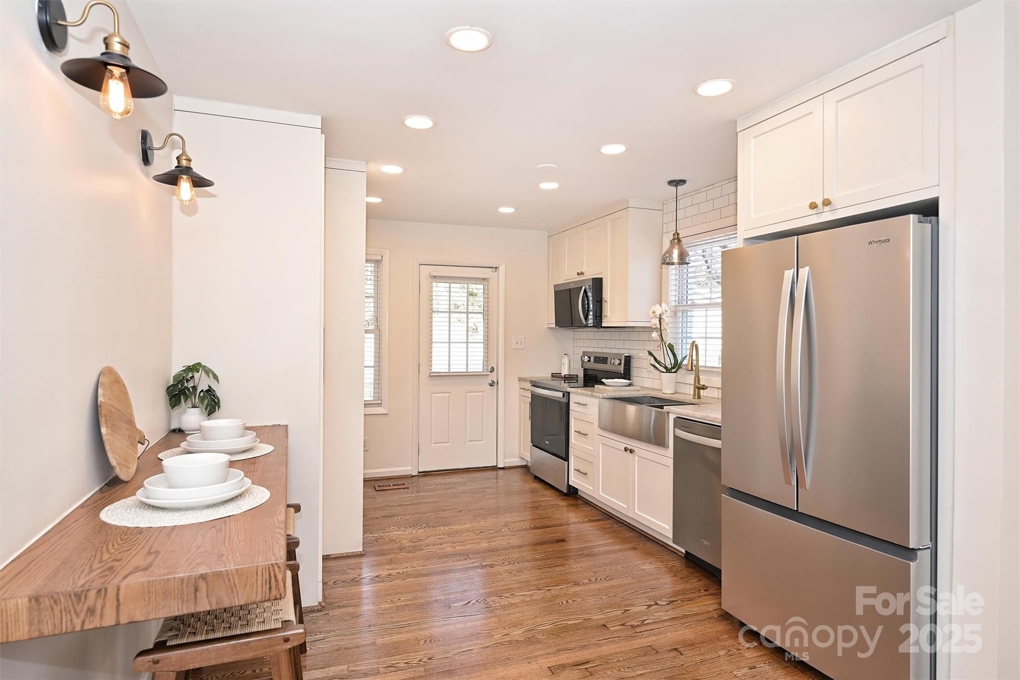 2730 Royston Road Charlotte, NC 28208 - Photo 11 of 40 a kitchen with a refrigerator a sink and chairs