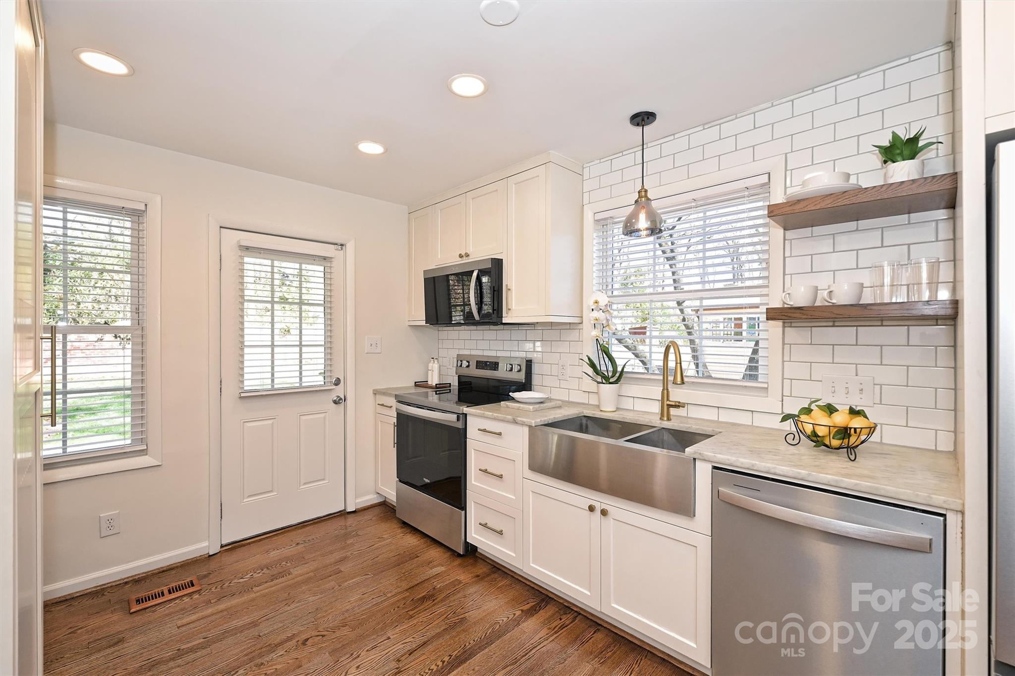 2730 Royston Road Charlotte, NC 28208 - Photo 13 of 40 a kitchen that has a sink and a stove top oven