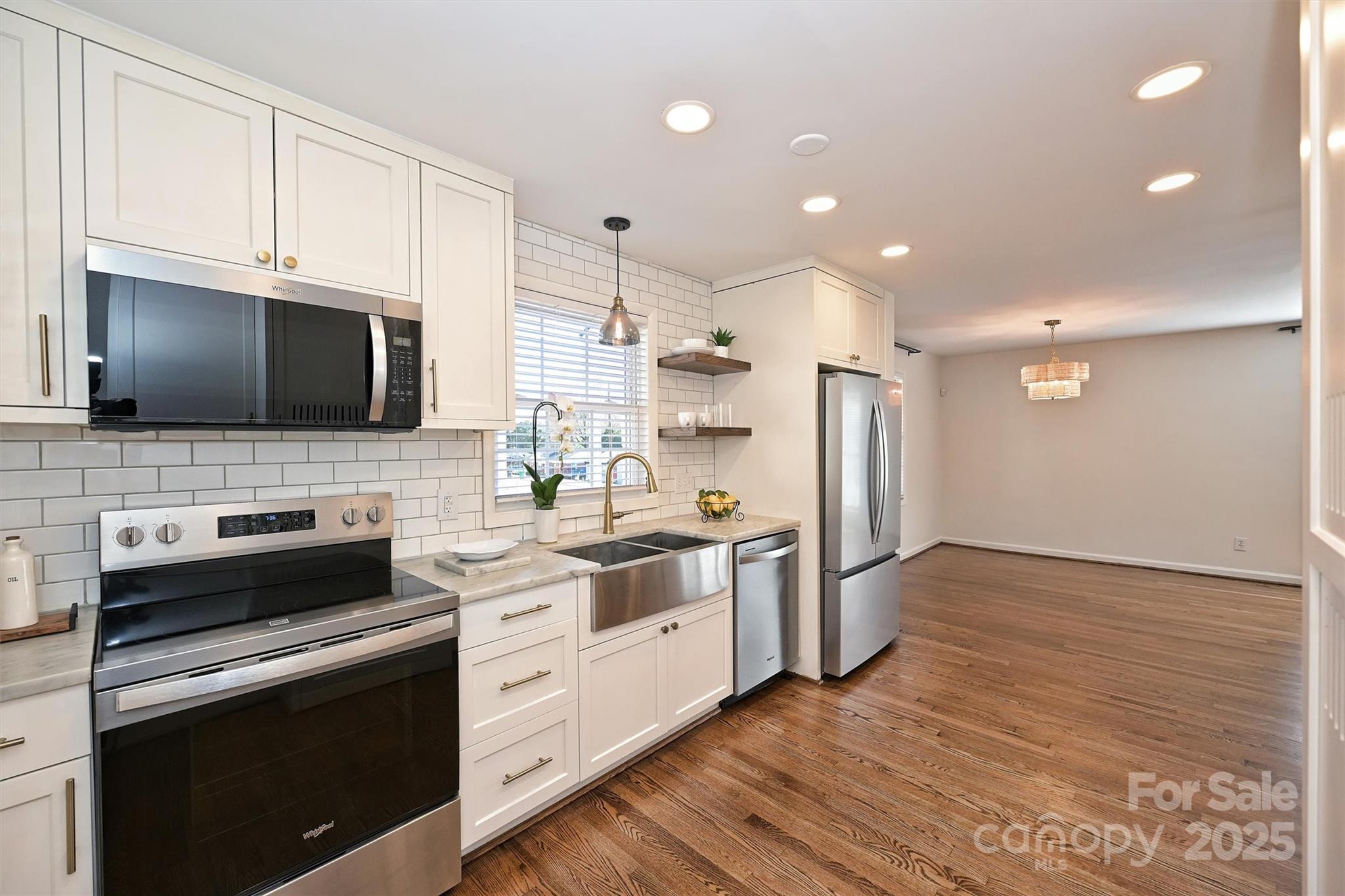 2730 Royston Road Charlotte, NC 28208 - Photo 14 of 40 a kitchen with stainless steel appliances a stove microwave and sink