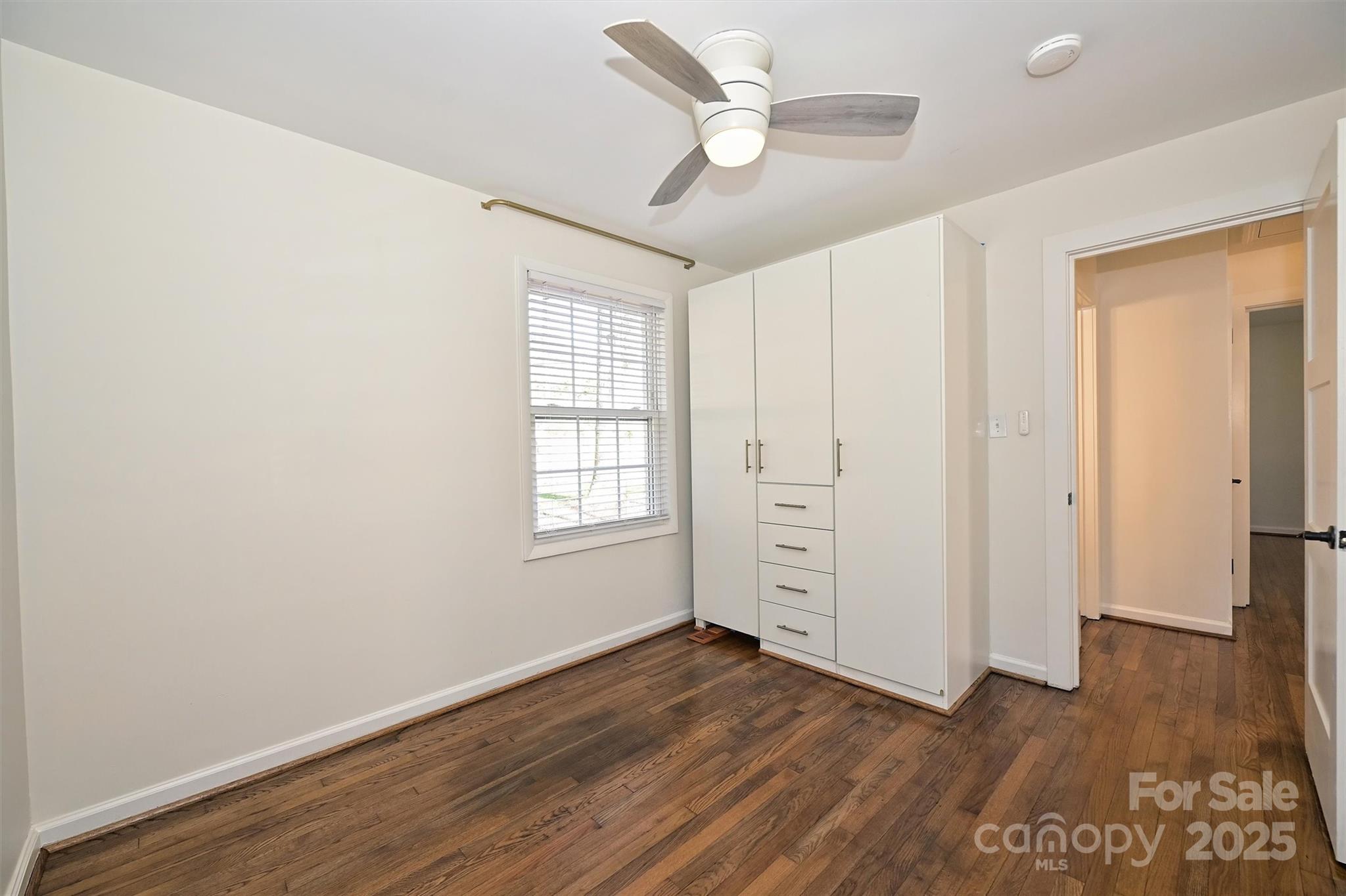2730 Royston Road Charlotte, NC 28208 - Photo 28 of 40 an empty room with wooden floor cabinet and windows