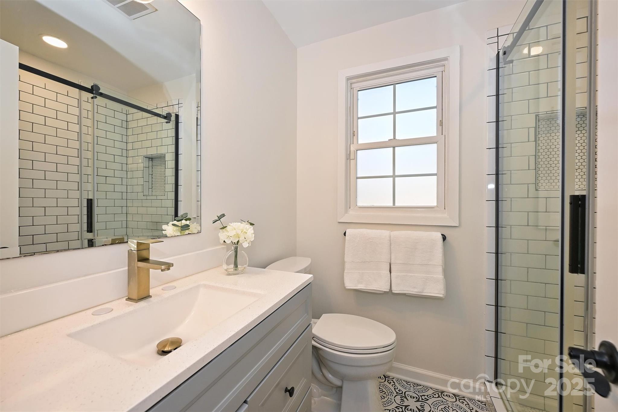 2730 Royston Road Charlotte, NC 28208 - Photo 29 of 40 a bathroom with a sink a toilet and shower