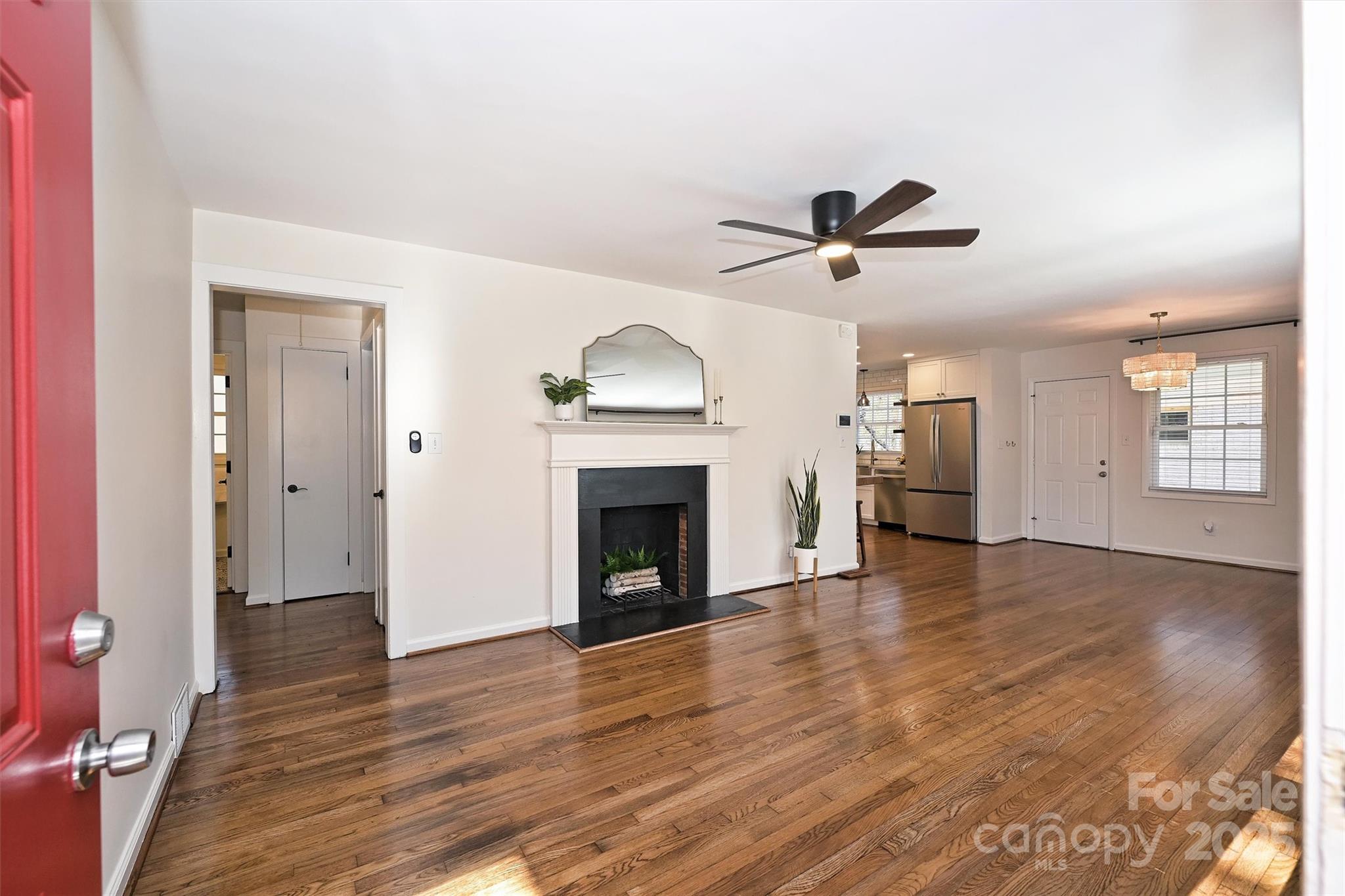 2730 Royston Road Charlotte, NC 28208 - Photo 4 of 40 wooden floor in an empty room with a fireplace