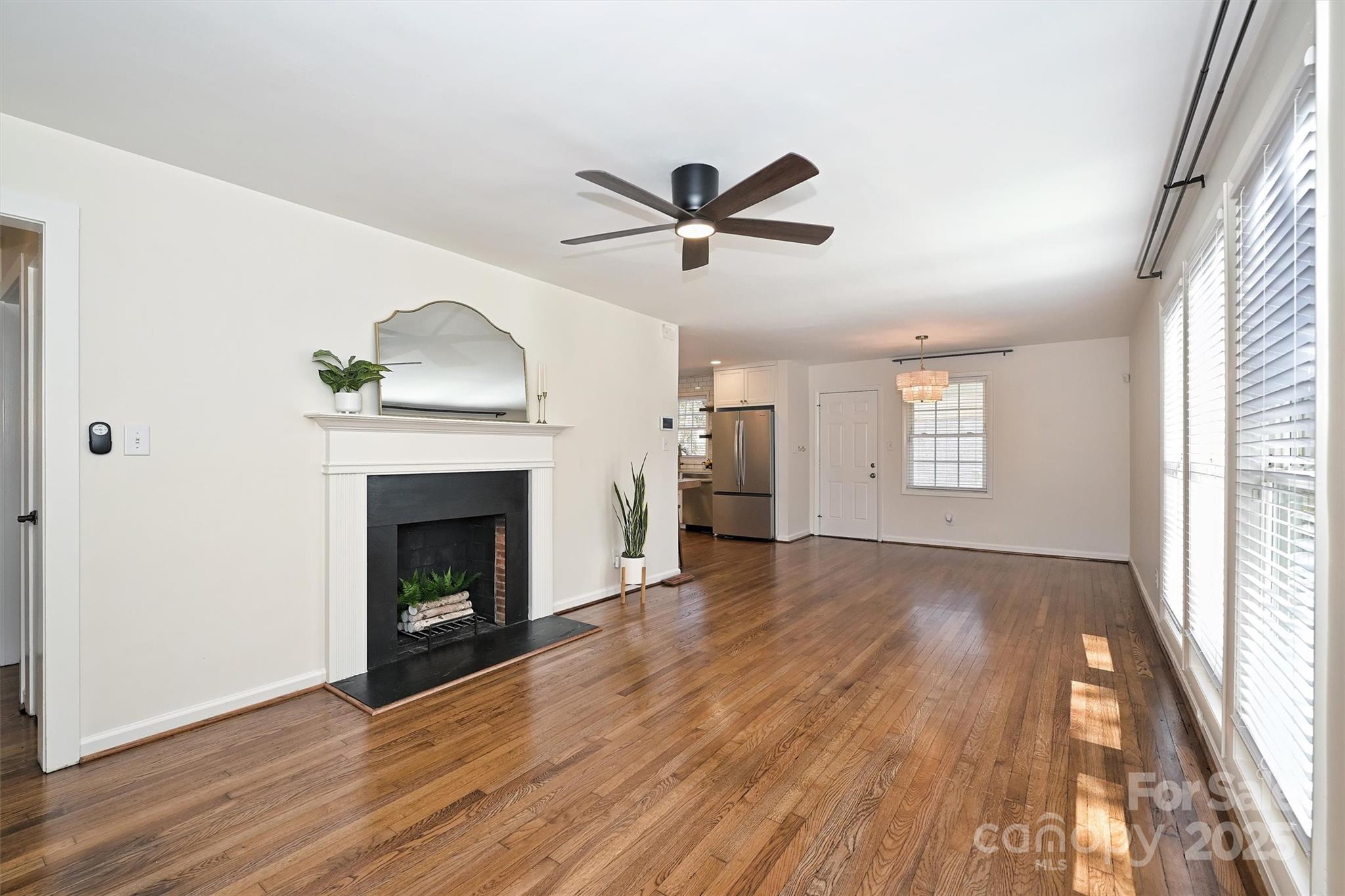 2730 Royston Road Charlotte, NC 28208 - Photo 5 of 40 a view of empty room with wooden floor and fireplace