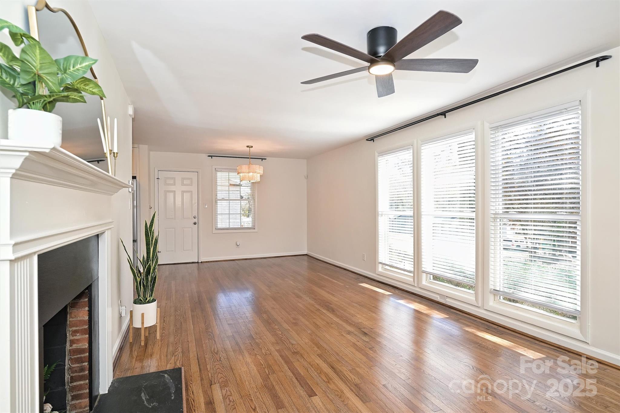 2730 Royston Road Charlotte, NC 28208 - Photo 6 of 40 a view of an empty room with a window and wooden floor
