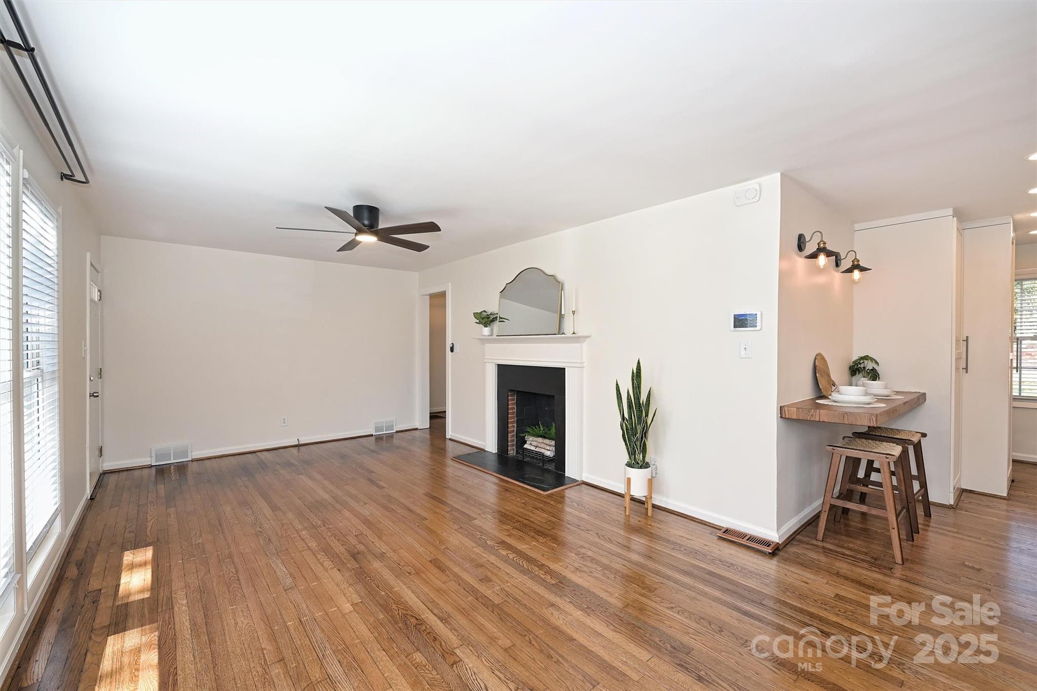 2730 Royston Road Charlotte, NC 28208 - Photo 8 of 40 a view of a livingroom with wooden floor and a fireplace