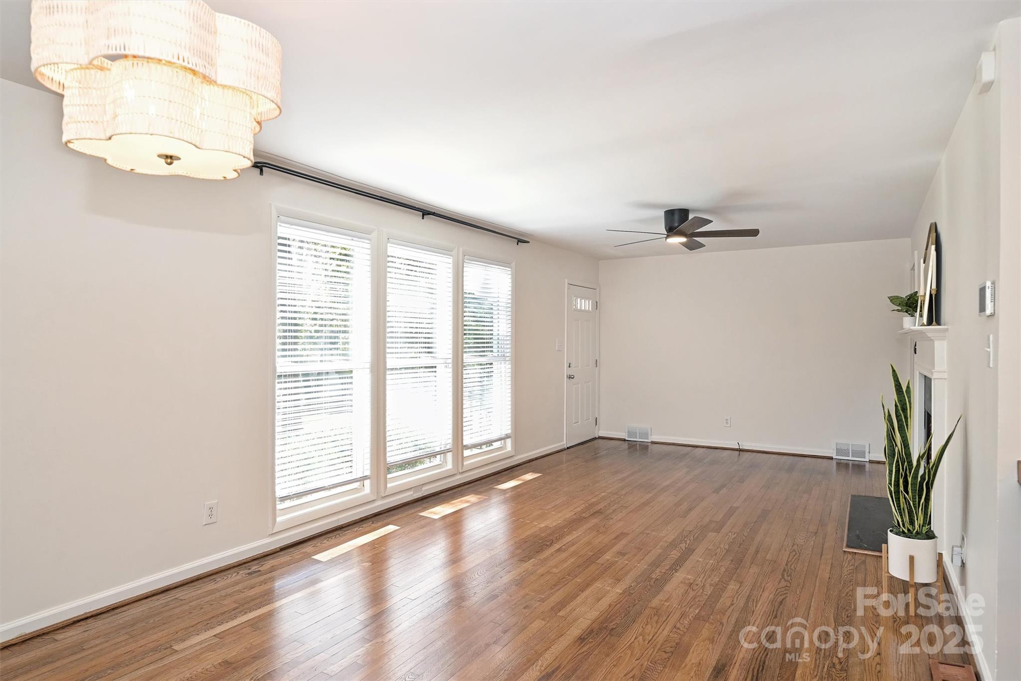 2730 Royston Road Charlotte, NC 28208 - Photo 9 of 40 an empty room with wooden floor and windows