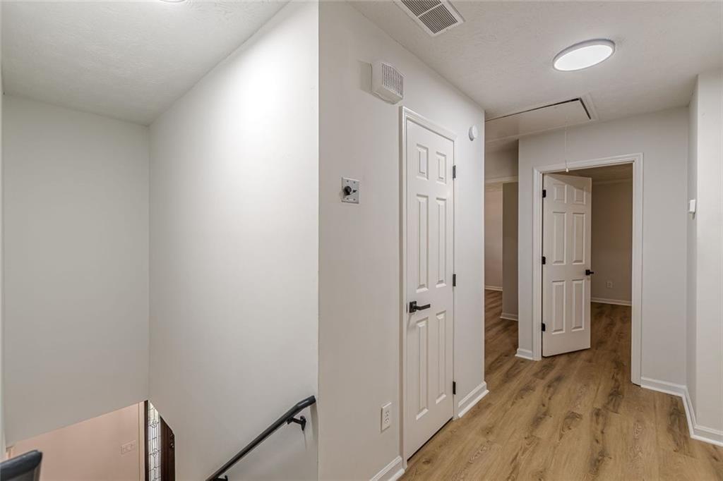 2011 Old Peachtree Road Northwest Duluth, GA 30097 - Photo 13 of 37 a view of a hallway with wooden floor and staircase