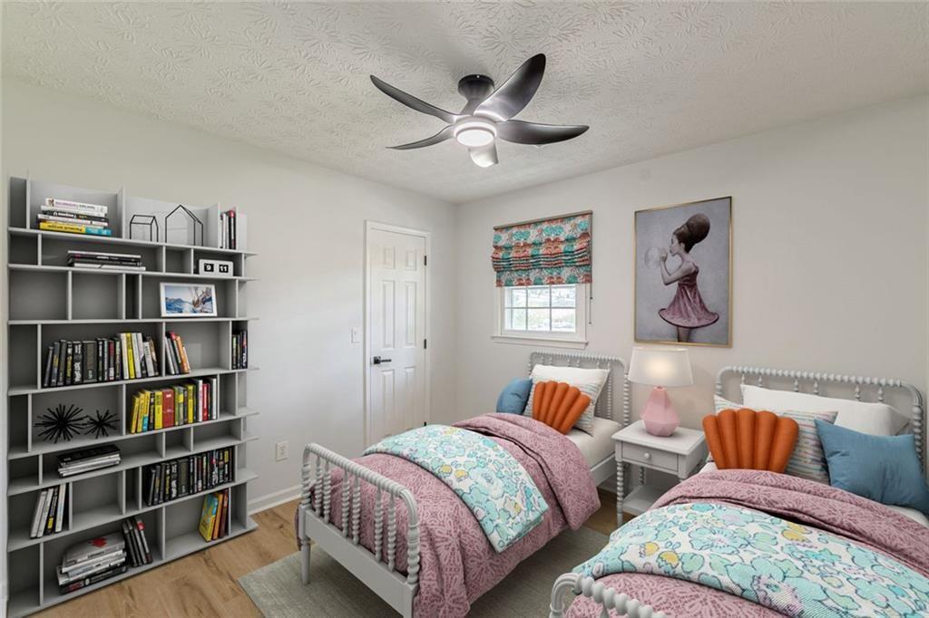 2011 Old Peachtree Road Northwest Duluth, GA 30097 - Photo 14 of 37 a bedroom with two bed and a book shelf