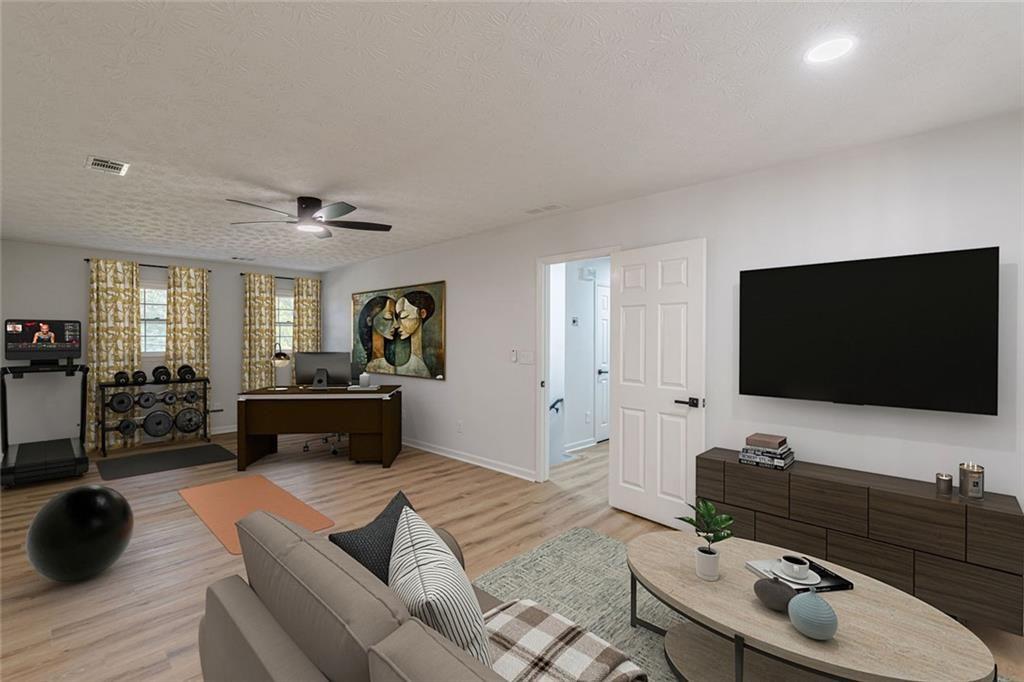 2011 Old Peachtree Road Northwest Duluth, GA 30097 - Photo 21 of 37 a living room with furniture and a flat screen tv
