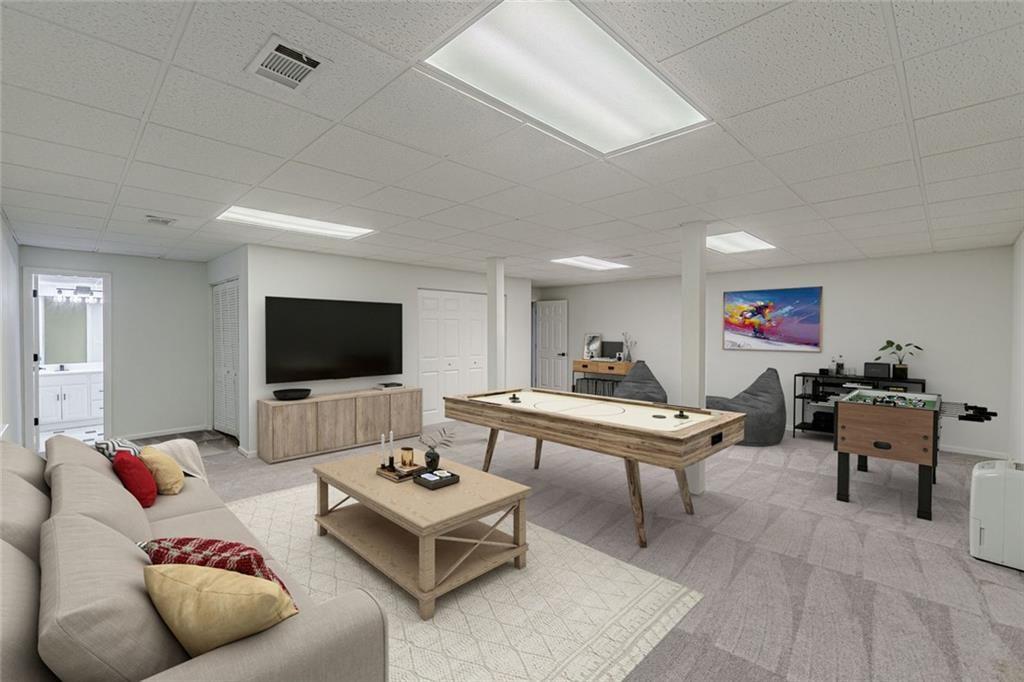 2011 Old Peachtree Road Northwest Duluth, GA 30097 - Photo 29 of 37 a living room with furniture and a flat screen tv