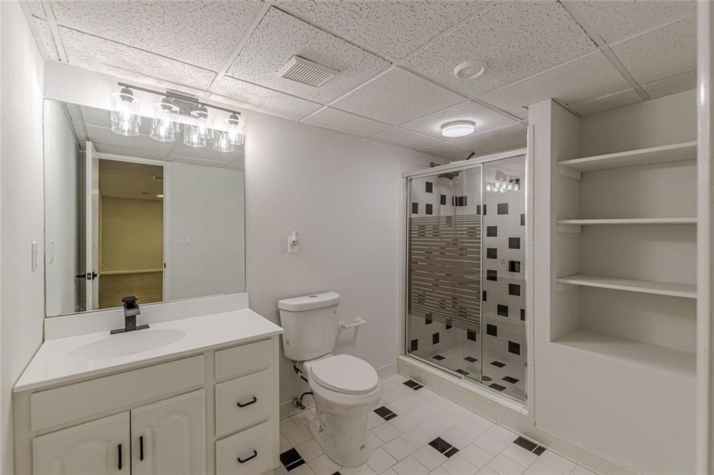 2011 Old Peachtree Road Northwest Duluth, GA 30097 - Photo 32 of 37 a bathroom with a sink a toilet and shower