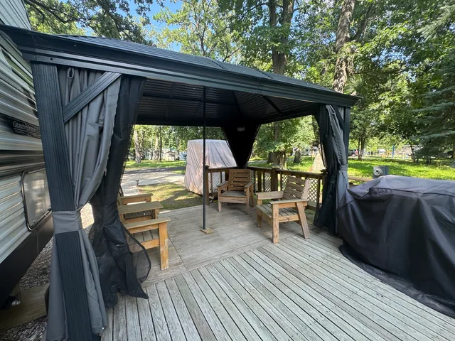 a view of roof deck with wooden floor and seating space