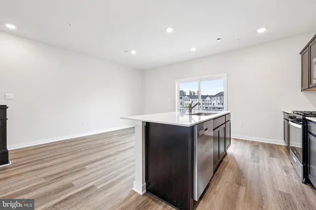 a kitchen with stainless steel appliances granite countertop a refrigerator and a stove
