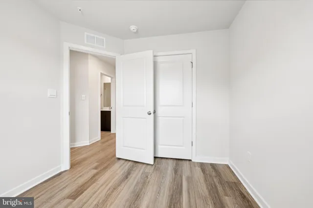 an empty room with wooden floor