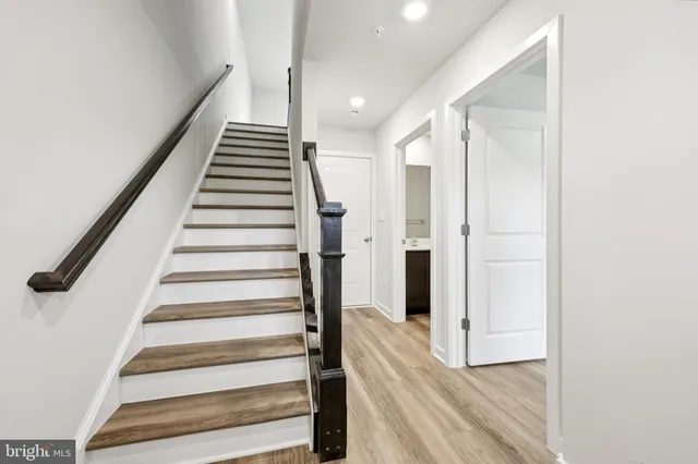 a view of entryway with wooden floor and stairs