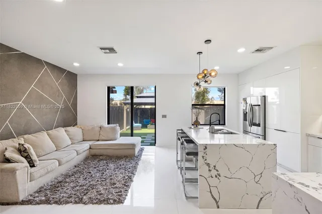 a living room with furniture and a chandelier