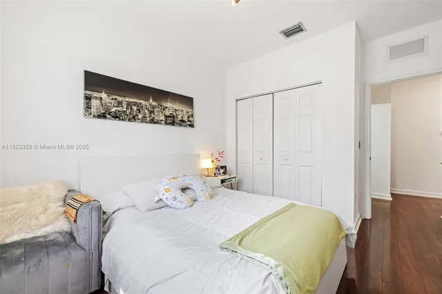 a bedroom with a bed and a potted plant