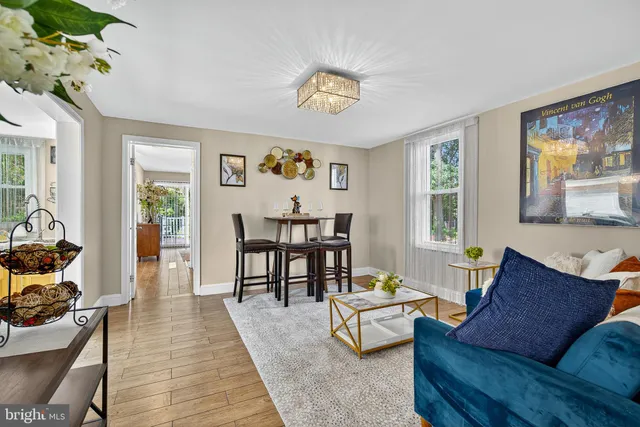 a living room with furniture wooden floor and a window