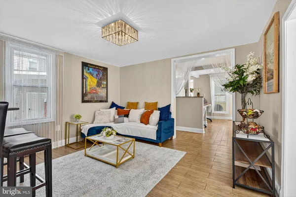 a living room with furniture and a potted plant