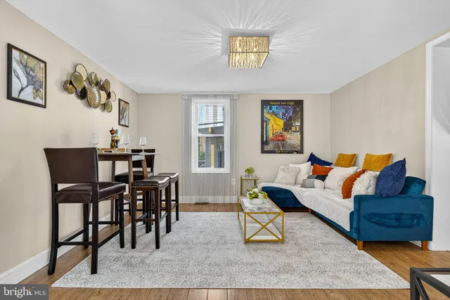 a living room with furniture and a dining table