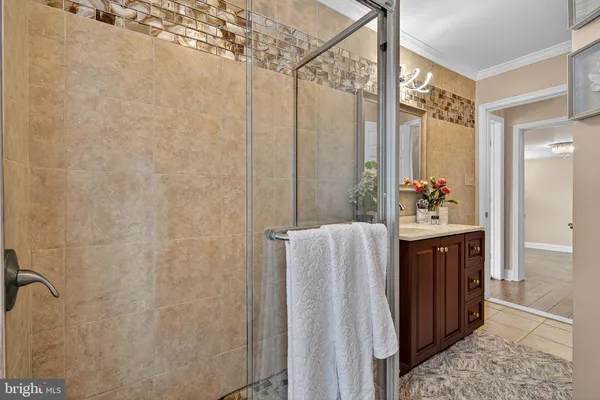 a bathroom with a sink a mirror and a shower
