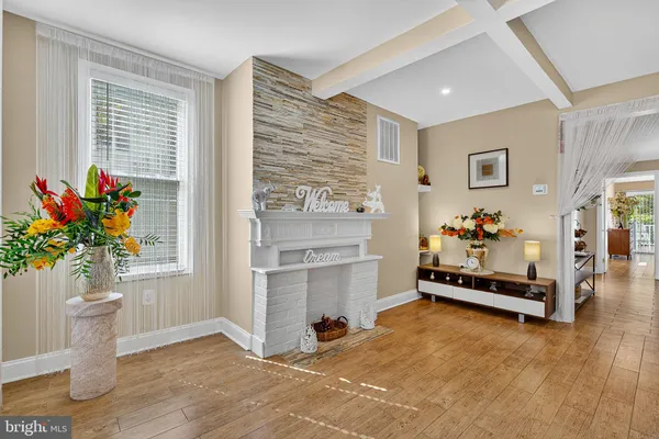 a living room with furniture and flowers
