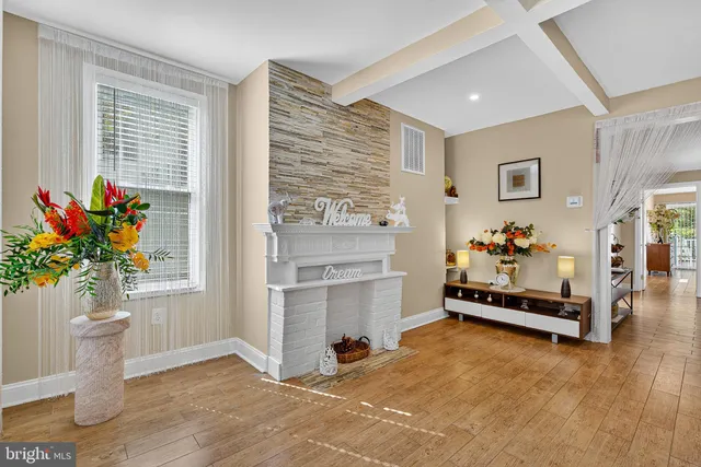 a living room with furniture and flowers